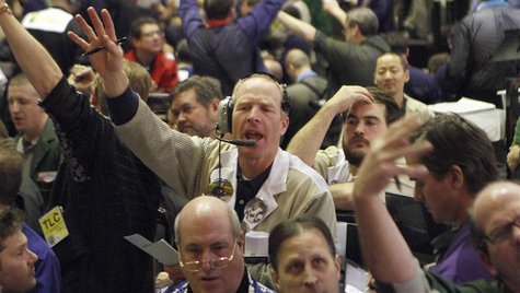 Traders in the corn options pit at the CME Group signal orders shortly before the closing bell in Chicago, in this February 11, 2011 file ph Traders in the corn options pit at the CME Group signal orders shortly before the closing bell in Chicago, in this February 11, 2011 file ph