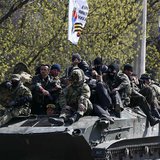 Armed men, wearing black and orange ribbons of St. George - a symbol widely associated with pro-Russian protests in Ukraine, drive an armour Armed men, wearing black and orange ribbons of St. George - a symbol widely associated with pro-Russian protests in Ukraine, drive an armour