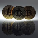 Mock Bitcoins are displayed on a table in an illustration picture taken in Berlin January 7, 2014. REUTERS/Pawel Kopczynski Mock Bitcoins are displayed on a table in an illustration picture taken in Berlin January 7, 2014. REUTERS/Pawel Kopczynski