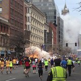 Runners continue to run towards the finish line of the Boston Marathon as an explosion erupts near the finish line of the race in this photo Runners continue to run towards the finish line of the Boston Marathon as an explosion erupts near the finish line of the race in this photo