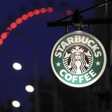 The sign outside a Starbucks coffee shop on in Westminster is seen with the London Eye in the background, in central London, December 3, 201 The sign outside a Starbucks coffee shop on in Westminster is seen with the London Eye in the background, in central London, December 3, 201