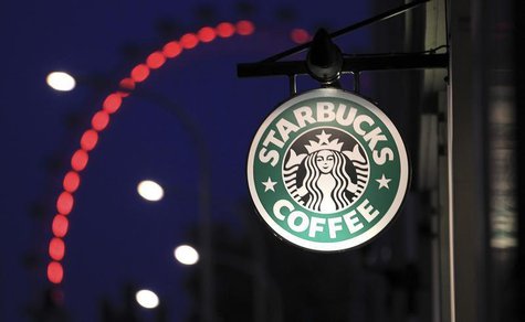 The sign outside a Starbucks coffee shop on in Westminster is seen with the London Eye in the background, in central London, December 3, 201 The sign outside a Starbucks coffee shop on in Westminster is seen with the London Eye in the background, in central London, December 3, 201