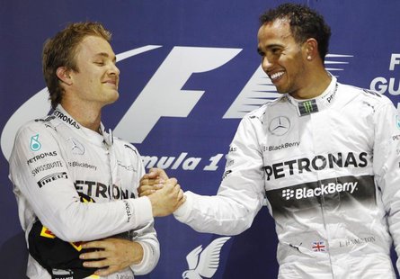 Mercedes Formula One driver Lewis Hamilton of Britain (R) is congratulated by teammate Mercedes Formula One driver Nico Rosberg of Germany o Mercedes Formula One driver Lewis Hamilton of Britain (R) is congratulated by teammate Mercedes Formula One driver Nico Rosberg of Germany o