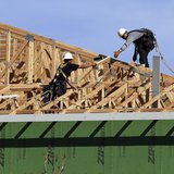 Workers install a roof on a multi-family building in Broomfield, Colorado February 19, 2014. REUTERS/Rick Wilking Workers install a roof on a multi-family building in Broomfield, Colorado February 19, 2014. REUTERS/Rick Wilking