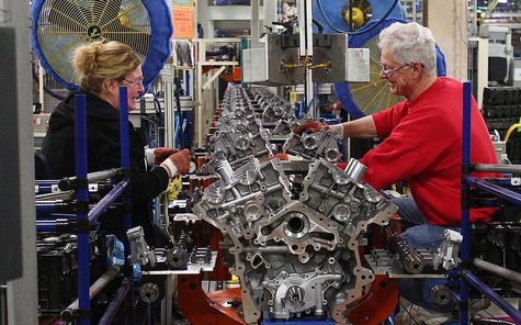 Ford assembly line employees work on 3500 Duramax engine as they move along the assembly line at the Ford Lima Engine Plant in Lima, Ohio, M Ford assembly line employees work on 3500 Duramax engine as they move along the assembly line at the Ford Lima Engine Plant in Lima, Ohio, M