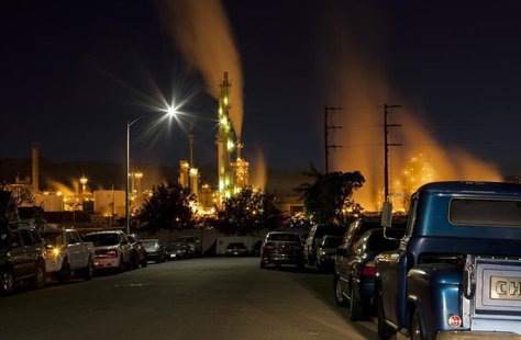 The ConocoPhillips oil refinery lights up a neighborhood in San Pedro, California March 24, 2012. Picture taken March 24, 2012. REUTERS/Bret The ConocoPhillips oil refinery lights up a neighborhood in San Pedro, California March 24, 2012. Picture taken March 24, 2012. REUTERS/Bret