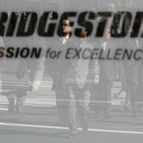 Pedestrians are reflected in a signboard of Bridgestone Corp. at its headquarters in Tokyo February 19, 2009. REUTERS/Kim Kyung-Hoon Pedestrians are reflected in a signboard of Bridgestone Corp. at its headquarters in Tokyo February 19, 2009. REUTERS/Kim Kyung-Hoon