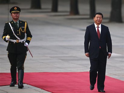 China's President Xi Jinping walks next to a honour guard during the welcoming ceremony for Serbian President Tomislav Nikolic outside the G China's President Xi Jinping walks next to a honour guard during the welcoming ceremony for Serbian President Tomislav Nikolic outside the G