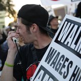 A man chants outside Wal-Mart during a protest for better wages and working conditions during Black Friday in San Leandro, California Novemb A man chants outside Wal-Mart during a protest for better wages and working conditions during Black Friday in San Leandro, California Novemb