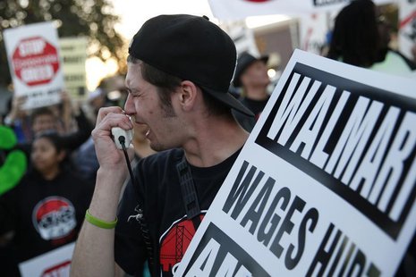 A man chants outside Wal-Mart during a protest for better wages and working conditions during Black Friday in San Leandro, California Novemb A man chants outside Wal-Mart during a protest for better wages and working conditions during Black Friday in San Leandro, California Novemb