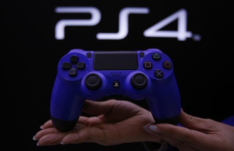 A staff at the PlayStation 4 launch event poses with the PlayStation 4's game controller before its domestic launch event at the Sony Showro A staff at the PlayStation 4 launch event poses with the PlayStation 4's game controller before its domestic launch event at the Sony Showro
