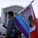A protester from Ohio carries a flag outside of the U.S. Supreme Court in Washington, March 26, 2013. REUTERS/Jonathan Ernst A protester from Ohio carries a flag outside of the U.S. Supreme Court in Washington, March 26, 2013. REUTERS/Jonathan Ernst