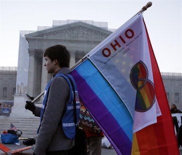 A protester from Ohio carries a flag outside of the U.S. Supreme Court in Washington, March 26, 2013. REUTERS/Jonathan Ernst A protester from Ohio carries a flag outside of the U.S. Supreme Court in Washington, March 26, 2013. REUTERS/Jonathan Ernst