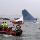 Part of South Korean passenger ship "Sewol" that has been sinking is seen as South Korean maritime policemen search for passengers in the sea off Jindo April 16, 2014. REUTERS/Hyung Min-woo/Yonhap Part of South Korean passenger ship "Sewol" that has been sinking is seen as South Korean maritime policemen search for passengers in the sea off Jindo April 16, 2014. REUTERS/Hyung Min-woo/Yonhap