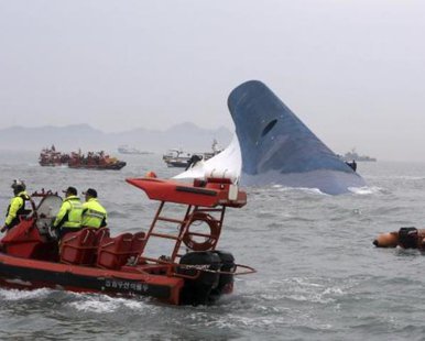 Part of South Korean passenger ship "Sewol" that has been sinking is seen as South Korean maritime policemen search for passengers in the sea off Jindo April 16, 2014. REUTERS/Hyung Min-woo/Yonhap Part of South Korean passenger ship "Sewol" that has been sinking is seen as South Korean maritime policemen search for passengers in the sea off Jindo April 16, 2014. REUTERS/Hyung Min-woo/Yonhap