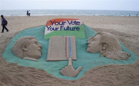 A visitor walks next to a sand sculpture on elections made by Indian sand artist Sudarshan Pattnaik at a beach at Puri in the eastern Indian A visitor walks next to a sand sculpture on elections made by Indian sand artist Sudarshan Pattnaik at a beach at Puri in the eastern Indian
