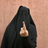 A veiled Muslim woman shows her ink-marked finger after voting outside a polling station in Doda district, north of Jammu, April 17, 2014. R A veiled Muslim woman shows her ink-marked finger after voting outside a polling station in Doda district, north of Jammu, April 17, 2014. R
