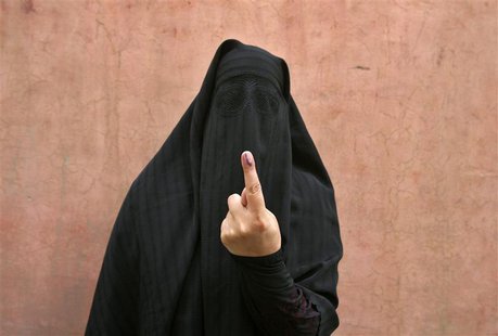 A veiled Muslim woman shows her ink-marked finger after voting outside a polling station in Doda district, north of Jammu, April 17, 2014. R A veiled Muslim woman shows her ink-marked finger after voting outside a polling station in Doda district, north of Jammu, April 17, 2014. R