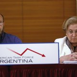 Horacio Vazquez (L), 56, from Buenos Aires, speaks while Eva Geller, 66, from Uruguay, looks down with other pensioners during a news confer Horacio Vazquez (L), 56, from Buenos Aires, speaks while Eva Geller, 66, from Uruguay, looks down with other pensioners during a news confer