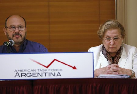 Horacio Vazquez (L), 56, from Buenos Aires, speaks while Eva Geller, 66, from Uruguay, looks down with other pensioners during a news confer Horacio Vazquez (L), 56, from Buenos Aires, speaks while Eva Geller, 66, from Uruguay, looks down with other pensioners during a news confer