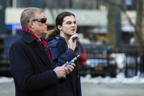 Pro-electronic cigarettes activists use their e-cigarettes before attending a city council meeting that will address the legality of indoor Pro-electronic cigarettes activists use their e-cigarettes before attending a city council meeting that will address the legality of indoor