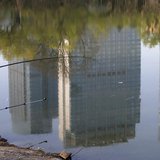 A man fishes next to a lake with the reflection of newly-built residential buildings at a park in Shenyang, Liaoning province, April 16, 201 A man fishes next to a lake with the reflection of newly-built residential buildings at a park in Shenyang, Liaoning province, April 16, 201