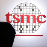 A man sits in front of the logo of Taiwan Semiconductor Manufacturing Co Ltd (TSMC) during an investors' conference in Taipei April 18, 2013 A man sits in front of the logo of Taiwan Semiconductor Manufacturing Co Ltd (TSMC) during an investors' conference in Taipei April 18, 2013