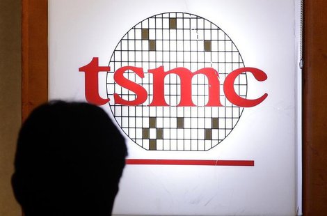 A man sits in front of the logo of Taiwan Semiconductor Manufacturing Co Ltd (TSMC) during an investors' conference in Taipei April 18, 2013 A man sits in front of the logo of Taiwan Semiconductor Manufacturing Co Ltd (TSMC) during an investors' conference in Taipei April 18, 2013