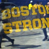 Pedestrians are reflected in a "Boston Strong" t-shirt displayed in a shop window, as they walk past the site of the first bomb blast from t Pedestrians are reflected in a "Boston Strong" t-shirt displayed in a shop window, as they walk past the site of the first bomb blast from t