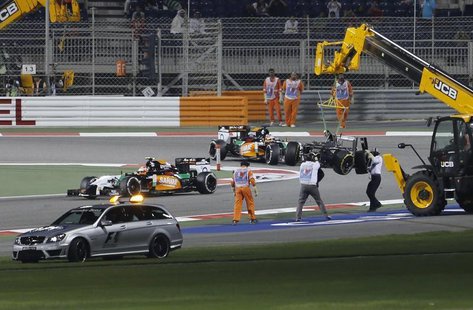 The car of Sauber Formula One driver Esteban Gutierrez of Mexico is removed from the track after his collision with Lotus Formula One driver The car of Sauber Formula One driver Esteban Gutierrez of Mexico is removed from the track after his collision with Lotus Formula One driver