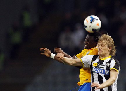 Juventus' Kwadwo Asamoah (L) jumps for the ball with Udinese's Dusan Basta during their Italian Serie A soccer match at the Friuli stadium i Juventus' Kwadwo Asamoah (L) jumps for the ball with Udinese's Dusan Basta during their Italian Serie A soccer match at the Friuli stadium i