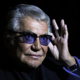Italian designer Roberto Cavalli acknowledges the audience at the end of his Spring/Summer 2014 collection during Milan Fashion Week Septemb Italian designer Roberto Cavalli acknowledges the audience at the end of his Spring/Summer 2014 collection during Milan Fashion Week Septemb