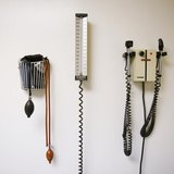 Devices used to take blood pressure, temperature, and examine eyes and ears rest on a wall inside of a doctor's office in New York March 22, Devices used to take blood pressure, temperature, and examine eyes and ears rest on a wall inside of a doctor's office in New York March 22,