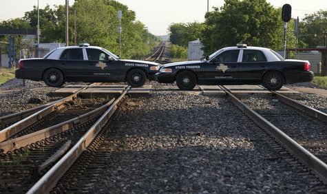 Texas State Troopers block a railway line leading towards a fertilizer plant explosion in the town of West, near Waco, Texas April 20, 2013. Texas State Troopers block a railway line leading towards a fertilizer plant explosion in the town of West, near Waco, Texas April 20, 2013.
