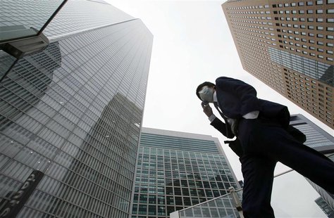 A businessman walks in Tokyo's business district April 18, 2014. REUTERS/Toru Hanai A businessman walks in Tokyo's business district April 18, 2014. REUTERS/Toru Hanai