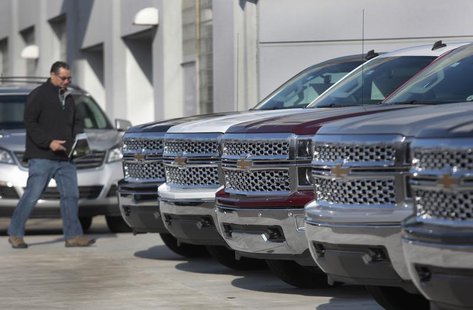 A man walks past a row of General Motors vehicles at a Chevrolet dealership on Woodward Avenue in Detroit, Michigan April 1, 2014. REUTERS/R A man walks past a row of General Motors vehicles at a Chevrolet dealership on Woodward Avenue in Detroit, Michigan April 1, 2014. REUTERS/R