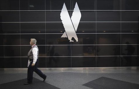 A man walks past an American Airlines logo on a wall at John F. Kennedy (JFK) airport in in New York November 27, 2013. REUTERS/Carlo Allegr A man walks past an American Airlines logo on a wall at John F. Kennedy (JFK) airport in in New York November 27, 2013. REUTERS/Carlo Allegr