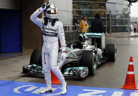 Mercedes Formula One driver Lewis Hamilton of Britain gestures while celebrating after taking pole position at the qualifying session of the Mercedes Formula One driver Lewis Hamilton of Britain gestures while celebrating after taking pole position at the qualifying session of the