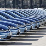 People walk past a row of Volkswagen e-Golf cars during the company's annual news conference in Berlin March 13, 2014. REUTERS/Tobias Schwar People walk past a row of Volkswagen e-Golf cars during the company's annual news conference in Berlin March 13, 2014. REUTERS/Tobias Schwar