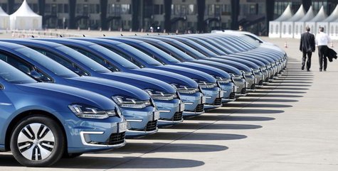 People walk past a row of Volkswagen e-Golf cars during the company's annual news conference in Berlin March 13, 2014. REUTERS/Tobias Schwar People walk past a row of Volkswagen e-Golf cars during the company's annual news conference in Berlin March 13, 2014. REUTERS/Tobias Schwar