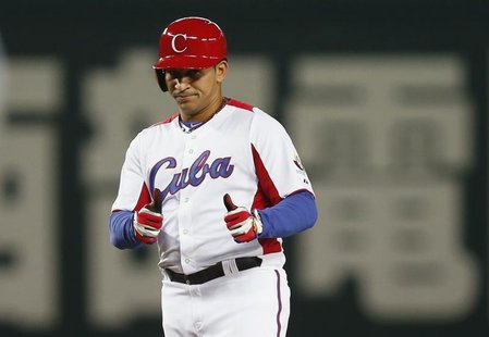 Cuba's Frederich Cepeda reacts after hitting an RBI double against Japan in the fourth inning at the World Baseball Classic (WBC) qualifying Cuba's Frederich Cepeda reacts after hitting an RBI double against Japan in the fourth inning at the World Baseball Classic (WBC) qualifying