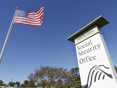 An American flag flutters in the wind next to signage for a United States Social Security Administration office in Burbank, California Octob An American flag flutters in the wind next to signage for a United States Social Security Administration office in Burbank, California Octob