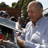 Chairman and CEO of McLaren Formula One team Ron Dennis signs autographs at the first practice session of the Australian F1 Grand Prix at th Chairman and CEO of McLaren Formula One team Ron Dennis signs autographs at the first practice session of the Australian F1 Grand Prix at th