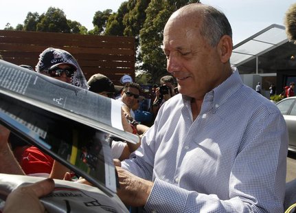 Chairman and CEO of McLaren Formula One team Ron Dennis signs autographs at the first practice session of the Australian F1 Grand Prix at th Chairman and CEO of McLaren Formula One team Ron Dennis signs autographs at the first practice session of the Australian F1 Grand Prix at th