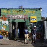 Residents stand outside a spaza convienience shop in Cape Town's Imizamo Yethu township, April 19, 2014. REUTERS/Mike Hutchings Residents stand outside a spaza convienience shop in Cape Town's Imizamo Yethu township, April 19, 2014. REUTERS/Mike Hutchings