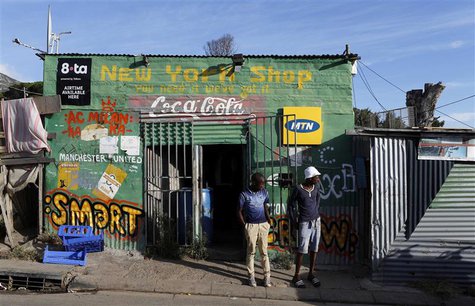Residents stand outside a spaza convienience shop in Cape Town's Imizamo Yethu township, April 19, 2014. REUTERS/Mike Hutchings Residents stand outside a spaza convienience shop in Cape Town's Imizamo Yethu township, April 19, 2014. REUTERS/Mike Hutchings