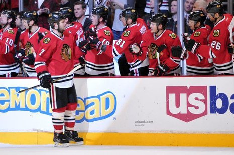 Jan 12, 2014; Chicago, IL, USA; Chicago Blackhawks defenseman Brent Seabrook (7) is congratulated by his teammates for scoring a goal agains Jan 12, 2014; Chicago, IL, USA; Chicago Blackhawks defenseman Brent Seabrook (7) is congratulated by his teammates for scoring a goal agains