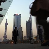 People walk along an elevated walkway at the Pudong financial district in Shanghai November 20, 2013. REUTERS/Carlos Barria People walk along an elevated walkway at the Pudong financial district in Shanghai November 20, 2013. REUTERS/Carlos Barria