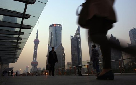 People walk along an elevated walkway at the Pudong financial district in Shanghai November 20, 2013. REUTERS/Carlos Barria People walk along an elevated walkway at the Pudong financial district in Shanghai November 20, 2013. REUTERS/Carlos Barria