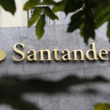 The logo of Spanish bank Santander is seen outside a building in Madrid October 27, 2011.REUTERS/Andrea Comas The logo of Spanish bank Santander is seen outside a building in Madrid October 27, 2011.REUTERS/Andrea Comas